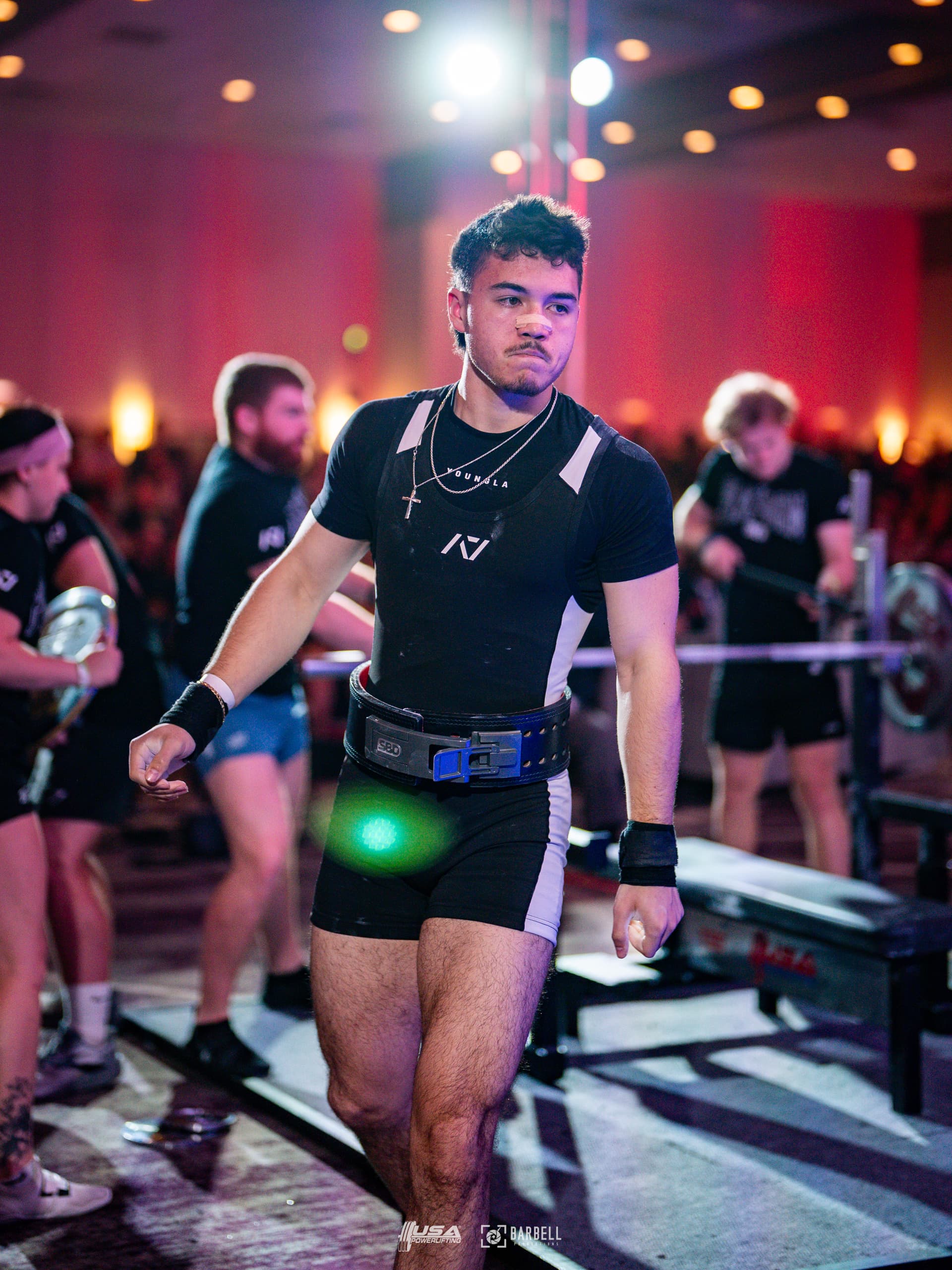 Coach Maylon McMurry walking out for a lift at a USA Powerlifting meet